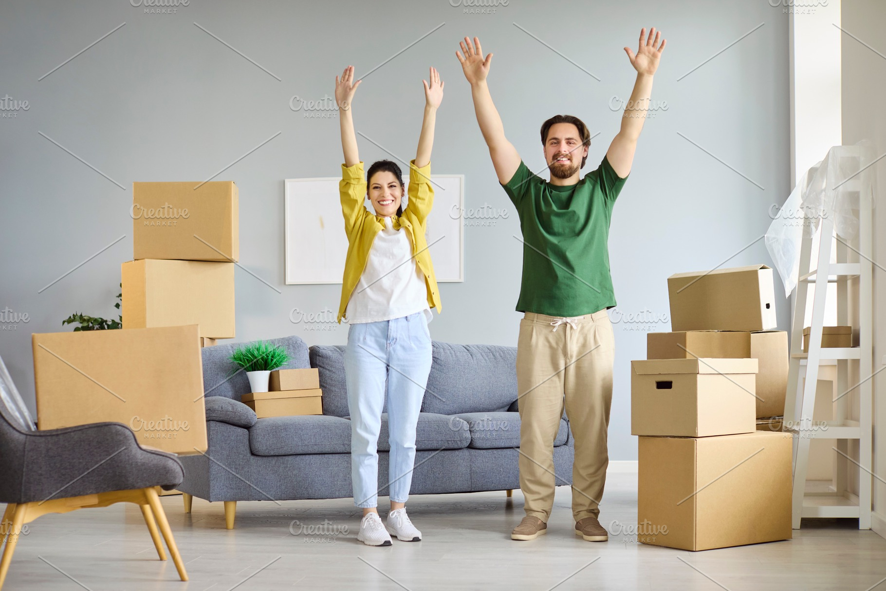 Couple Cheering Among Moving Boxes, a Person Photo by StudioRomantic