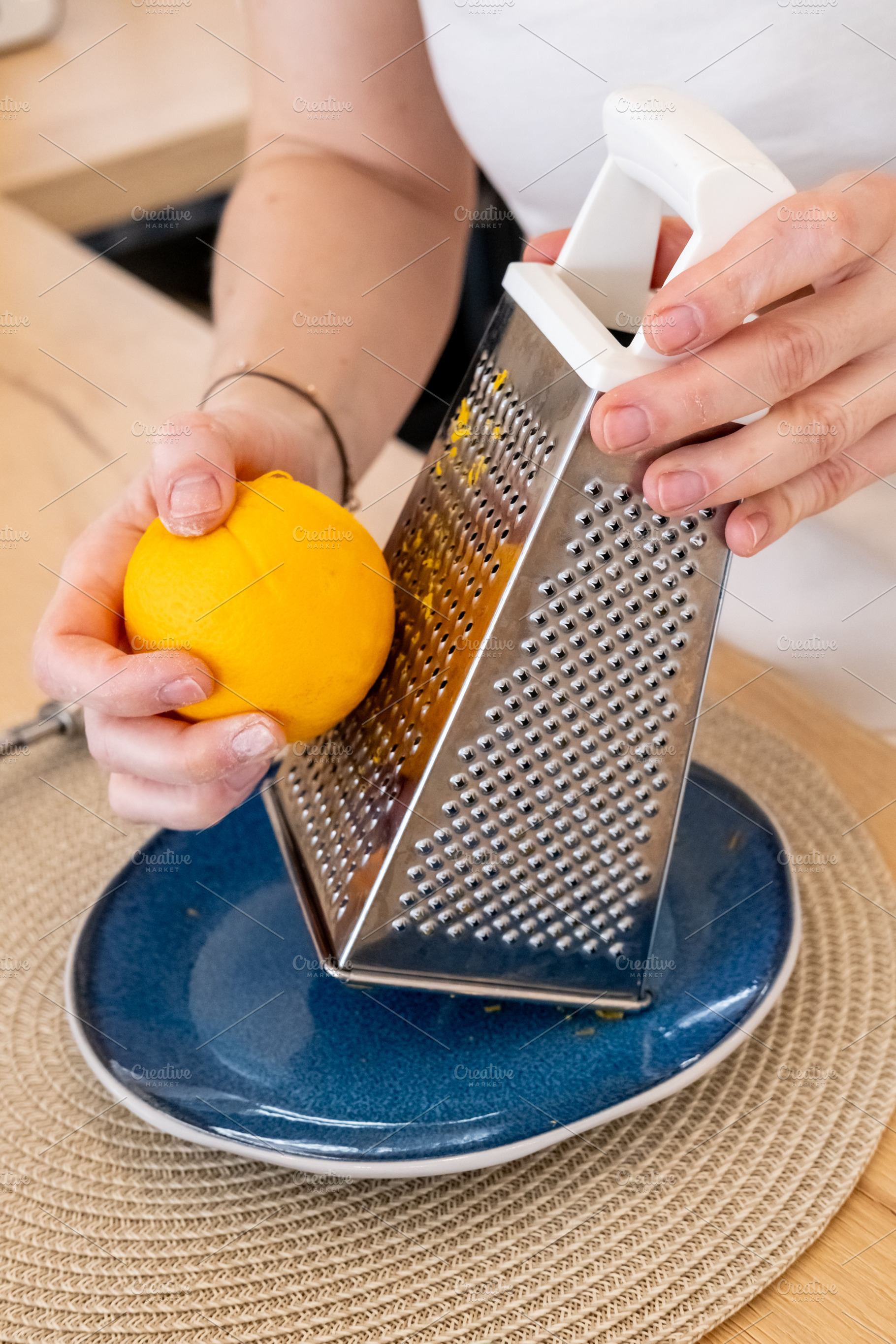 Culinary process zest grating chef hand orange, a Person Photo by Photo Drive Studio