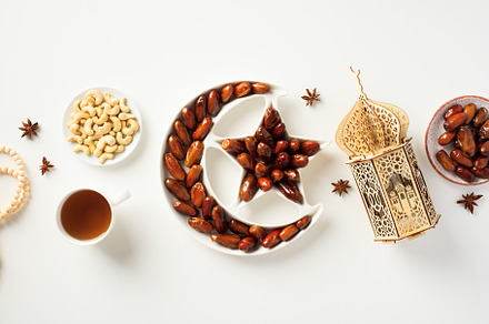 Ramadan Kareem concept. Islamic star and crescent bowl with dried dates, nuts,, a Holiday Photo by photoguns