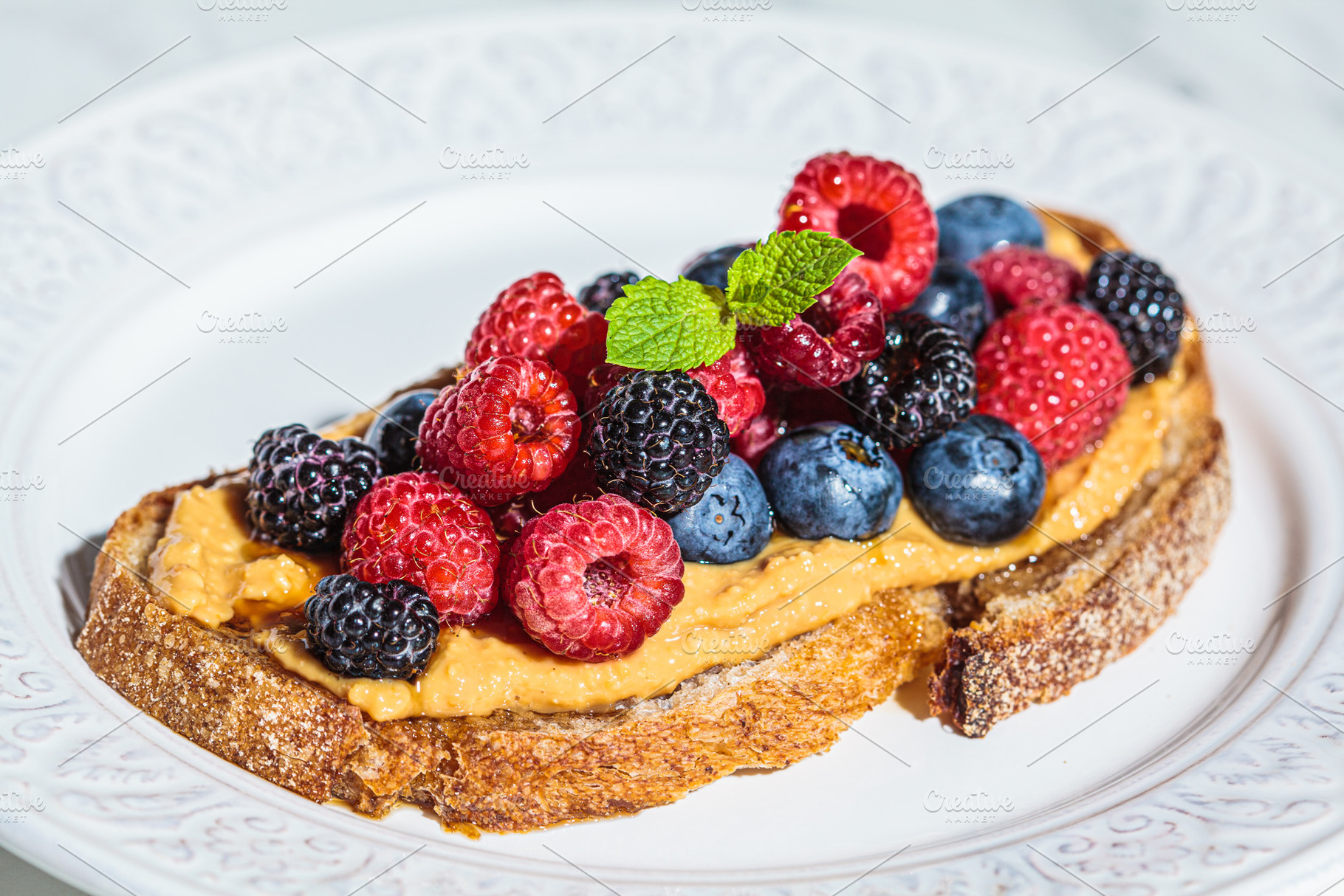 Toast with peanut butter and berry, a Food & Drink Photo by vaaseenaa