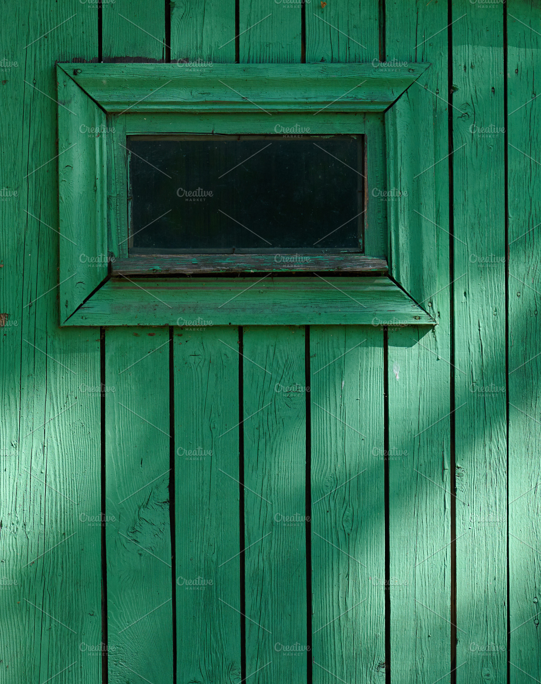 A fragment of an old wooden wall with a small window painted gre, a Nature Photo by ndanko