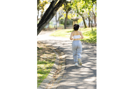 A woman is running on a path in a