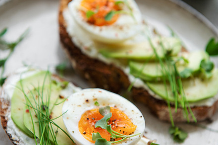 Bread toast, boiled eggs, avocado slice, microgreens on a plate, a Food & Drink Photo by Olena Rudo