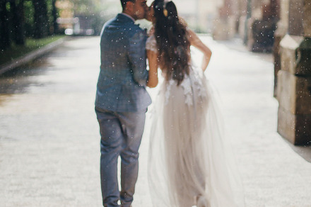Rain drops on background of blurred stylish bride and groom walk, a Person Photo by Sonjachni