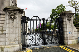 Ornate wrought iron gate and stone entrance to civic building in