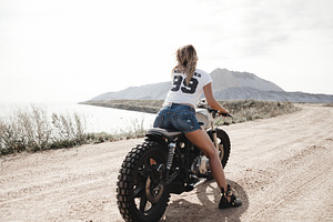 Sexy girl biker and cafe racer featuring wheels, motorcyclist, and female, a Transportation Photo by Aliaksei Kaponia