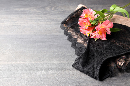 Concept of womens clothes with underwear on gray wooden backgrou, a Beauty & Fashion Photo by AtlasStudio