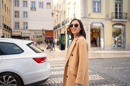 Happy caucasian girl walking city street on sunny autumn day, a Person Photo by andreonegin market