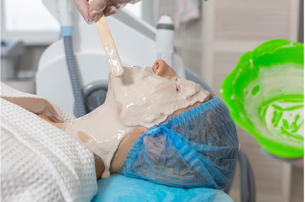 The cosmetologist applying an