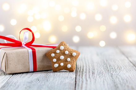 Gingerbread star and box of gift on bokeh lights background, a Holiday Photo by dashtik