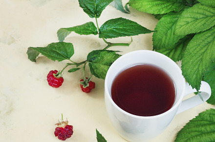 Raspberry tea with leaves and raspbe featuring raspberry, tea, and glass