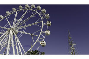 White ferris wheel rotating under, a Sports & Recreation Photo by Media Whale Stock