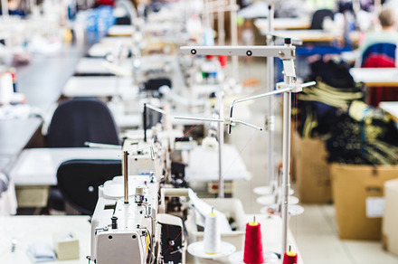 Interior of garment factory shop containing machine, industry, and material