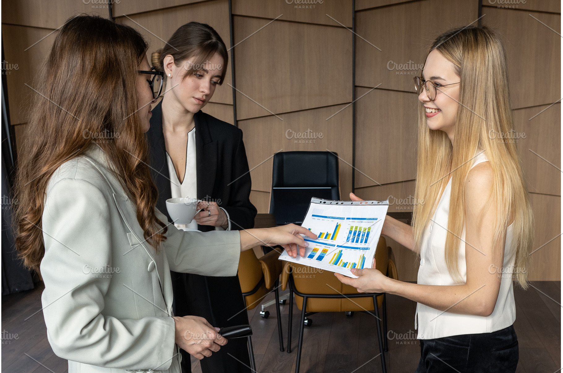 Women in a modern office engaged in, a Business Photo by undrey
