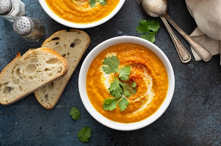 Pumpkin soup served with cream and cilantro, a Food & Drink Photo by farwasser