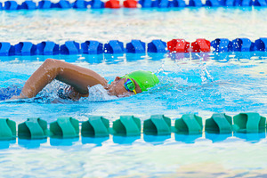 Swimmer child swims freestyle swimming style in a race swimming