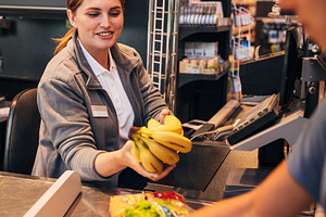 Cheerful female working as a cashier, a Person Photo by Artem Varnitsin