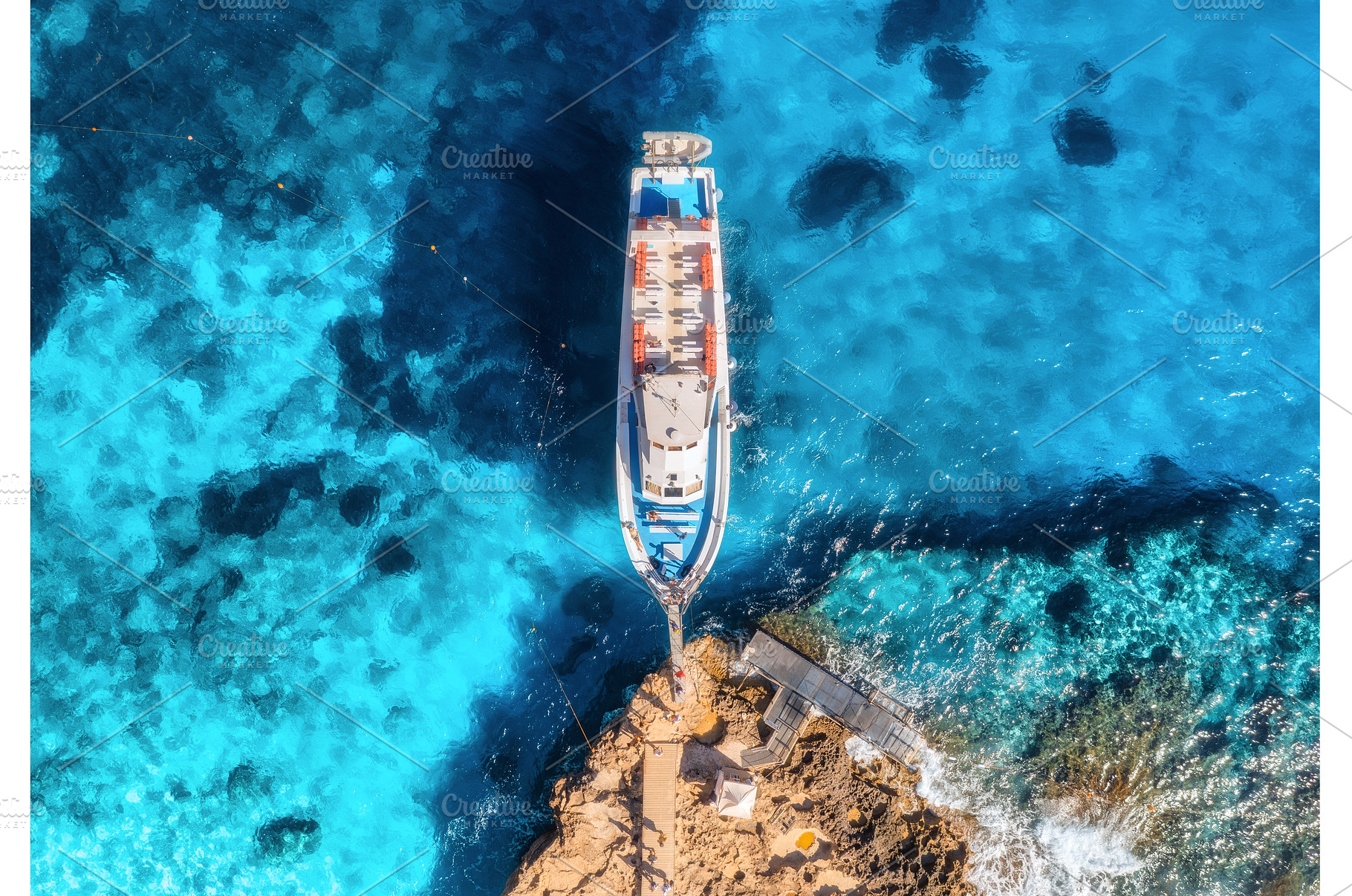 Aerial view of boat and rocky sea, a Transportation Photo by den-belitsky