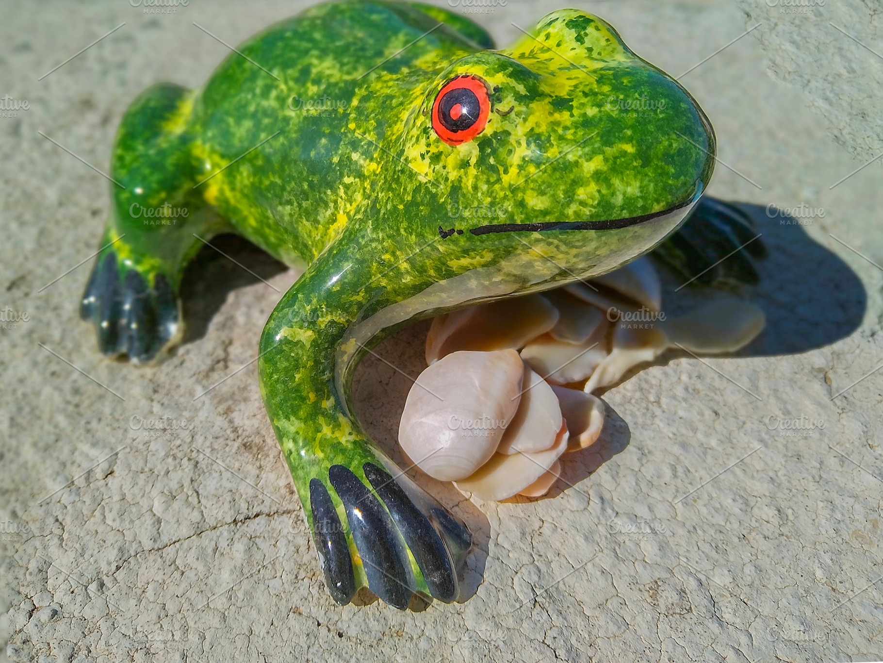 Playful frog sculpture under bright sunlight, an Animal Photo by DanFLCreativo