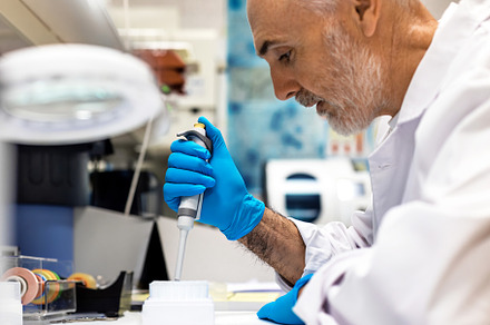 Selective focus of a scientist using, a Health & Medical Photo by Perpis