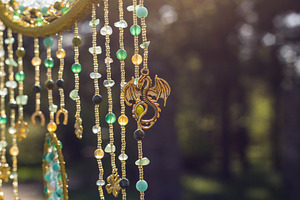 Handmade dream catcher with feathers featuring amulet, art, and background