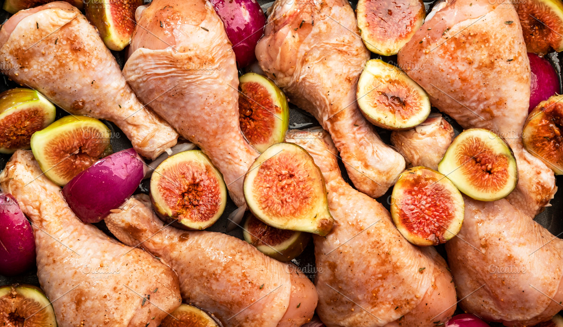 Raw chicken legs, drumsticks with sweet figs and red onions in b, a Food & Drink Photo by 5PH
