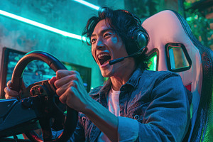 Gamer intensely plays racing game ne, a Photo by Pixeness Studio