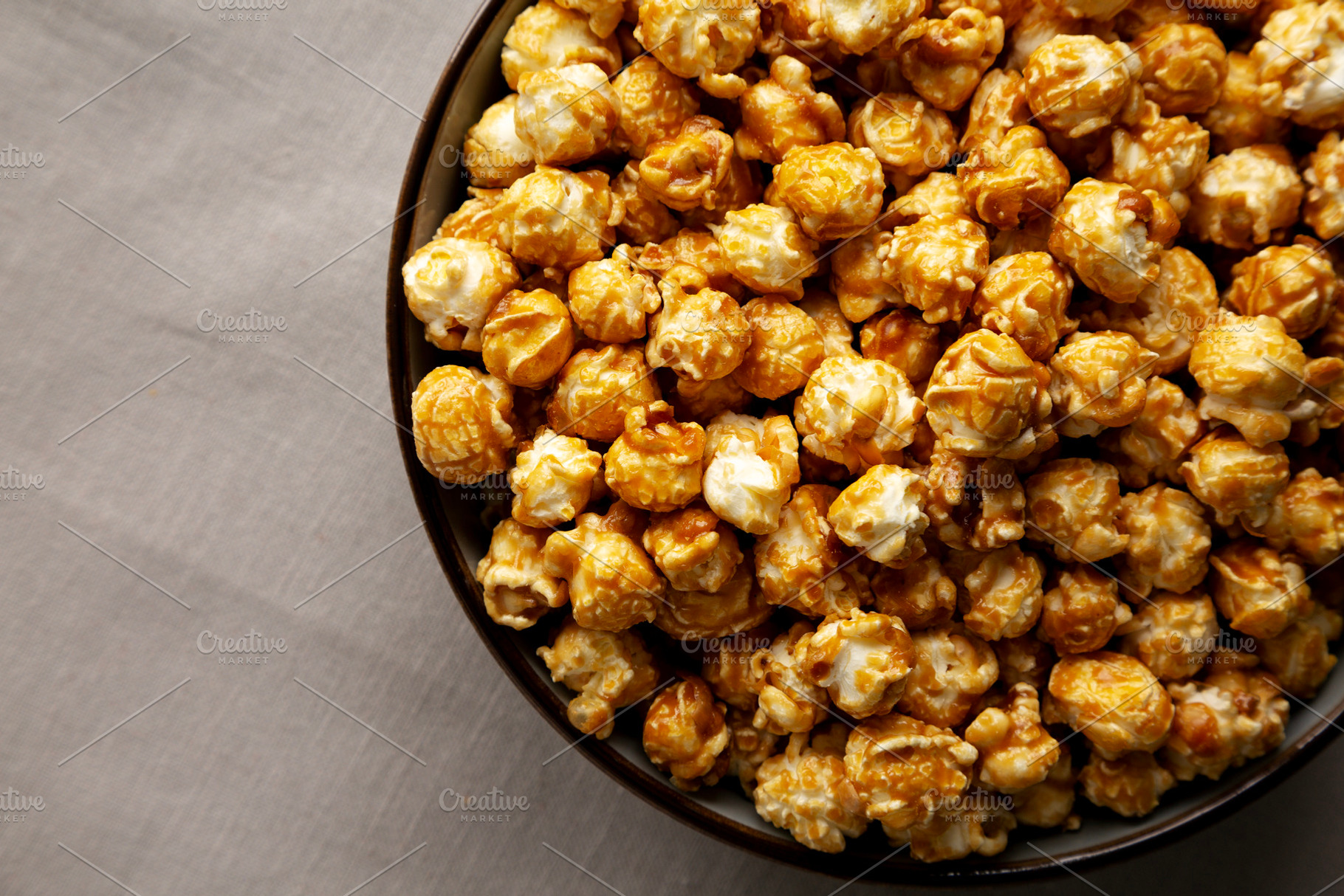 Homemade Caramel Pop Corn in a Bowl, top view., a Food & Drink Photo by LiudmylaChuhunova