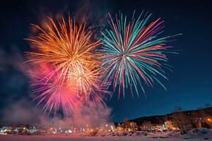 Colorful fireworks display over snowy landscape, a Holiday Photo by AlyaAnd