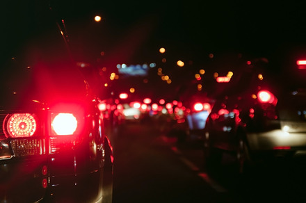 Car taillights in blur on the evening road at rush hour, a Transportation Photo by TanaCh