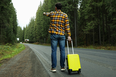 Adventure and tourism concept, young man traveling by auto stop, a Nature Photo by AtlasStudio PRO