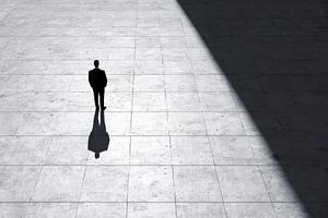 Man stands alone in a large, a Photo by Pavel_design