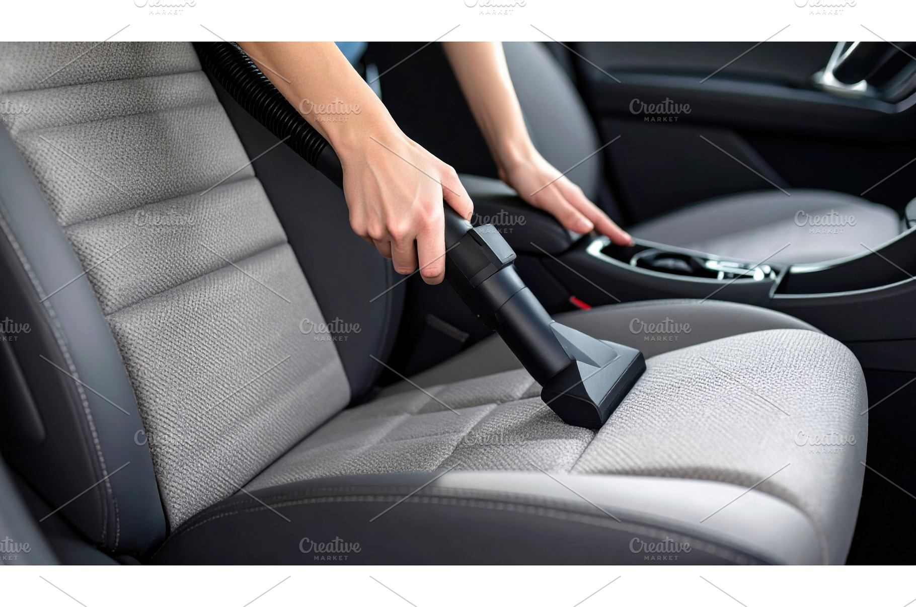 Vacuuming a car seat symbolizing, a Transportation Photo by Igor Tichonow