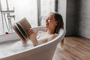 Happy woman lying in foamy bath, reading book in relaxing atmosphere, enjoying, a Photo by Prostock-Studio (Thumbnail 1 of 2)