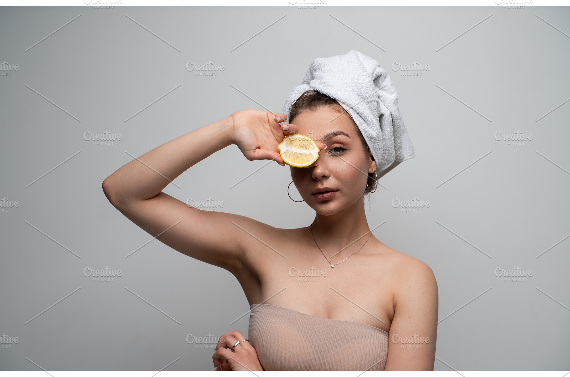 Young woman with a towel wrapped, a Health & Medical Photo by volodymyrshtun13795