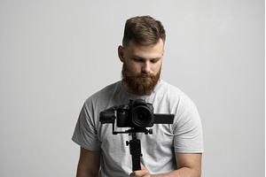 Bearded man holding professional, a Person Photo by volodymyrshtun13795