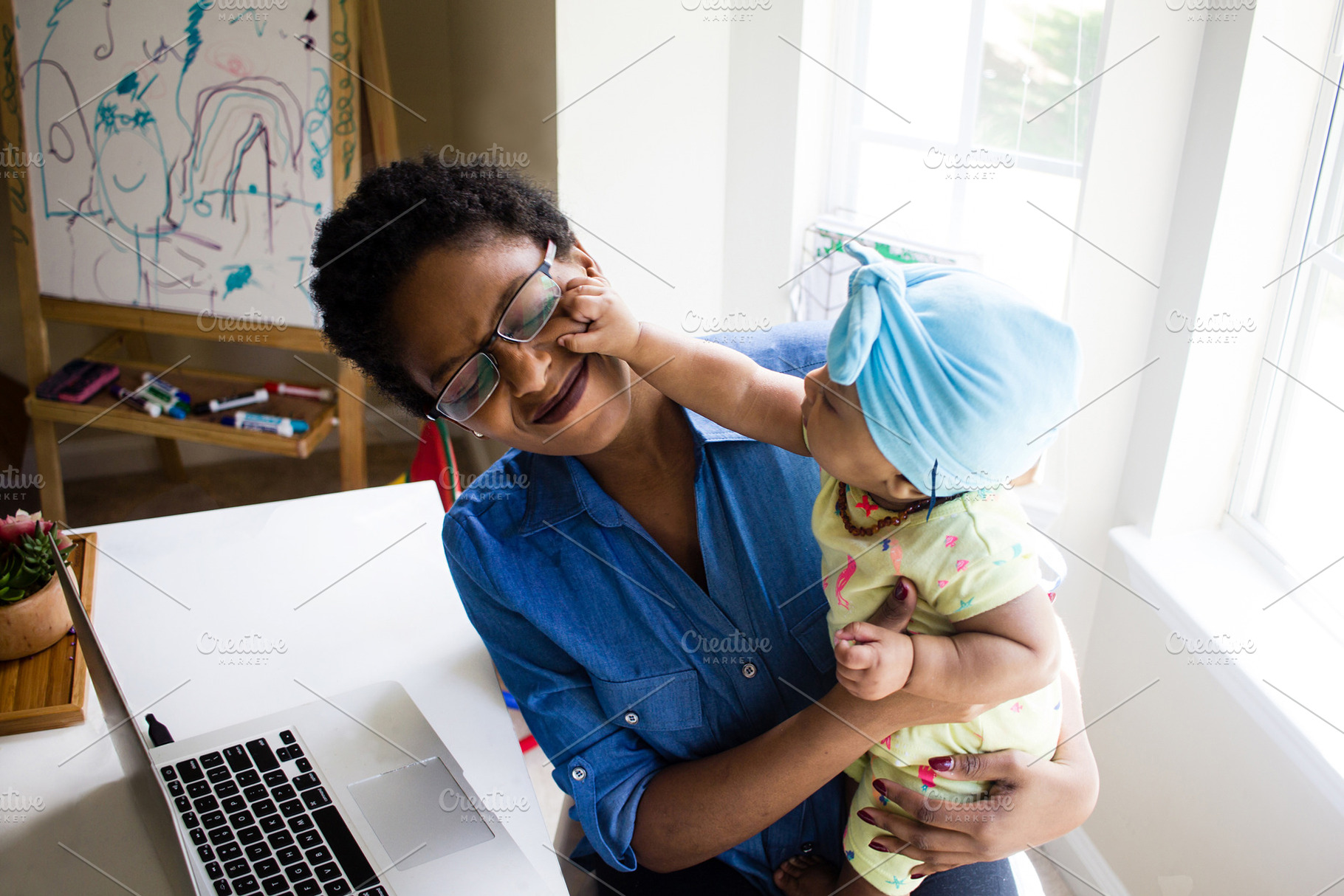 African american woman with baby stock photo containing mompreneur and black, a Person Photo by HUNCreative