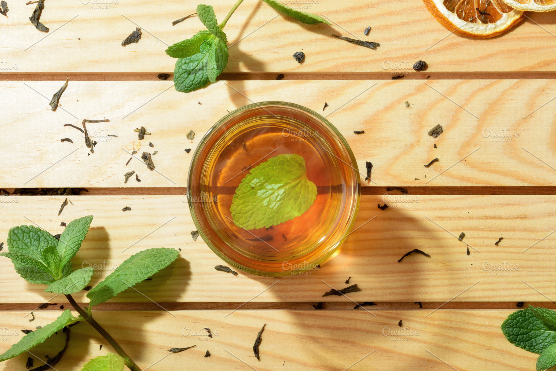 Green tea in the center of wooden table with leaves, a Food & Drink Photo by Davizro's Market