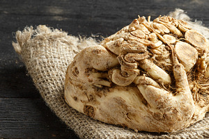 celery root and burlap on dark wooden background