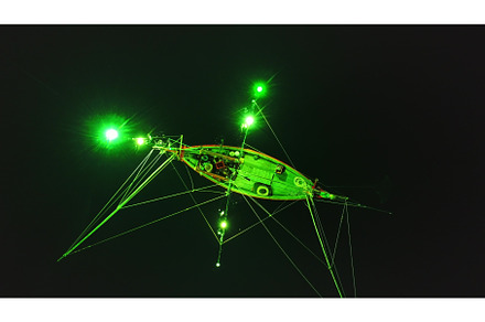 Squid fishing boat illuminating the