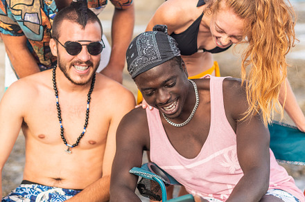 four multiracial friends having a good time at the beach, a Holiday Photo by Iván Moreno STOCK PHOTO