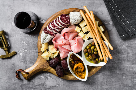 Italian snack and antipasti on a tray and red wine: prosciutto,, a Food & Drink Photo by IriGri