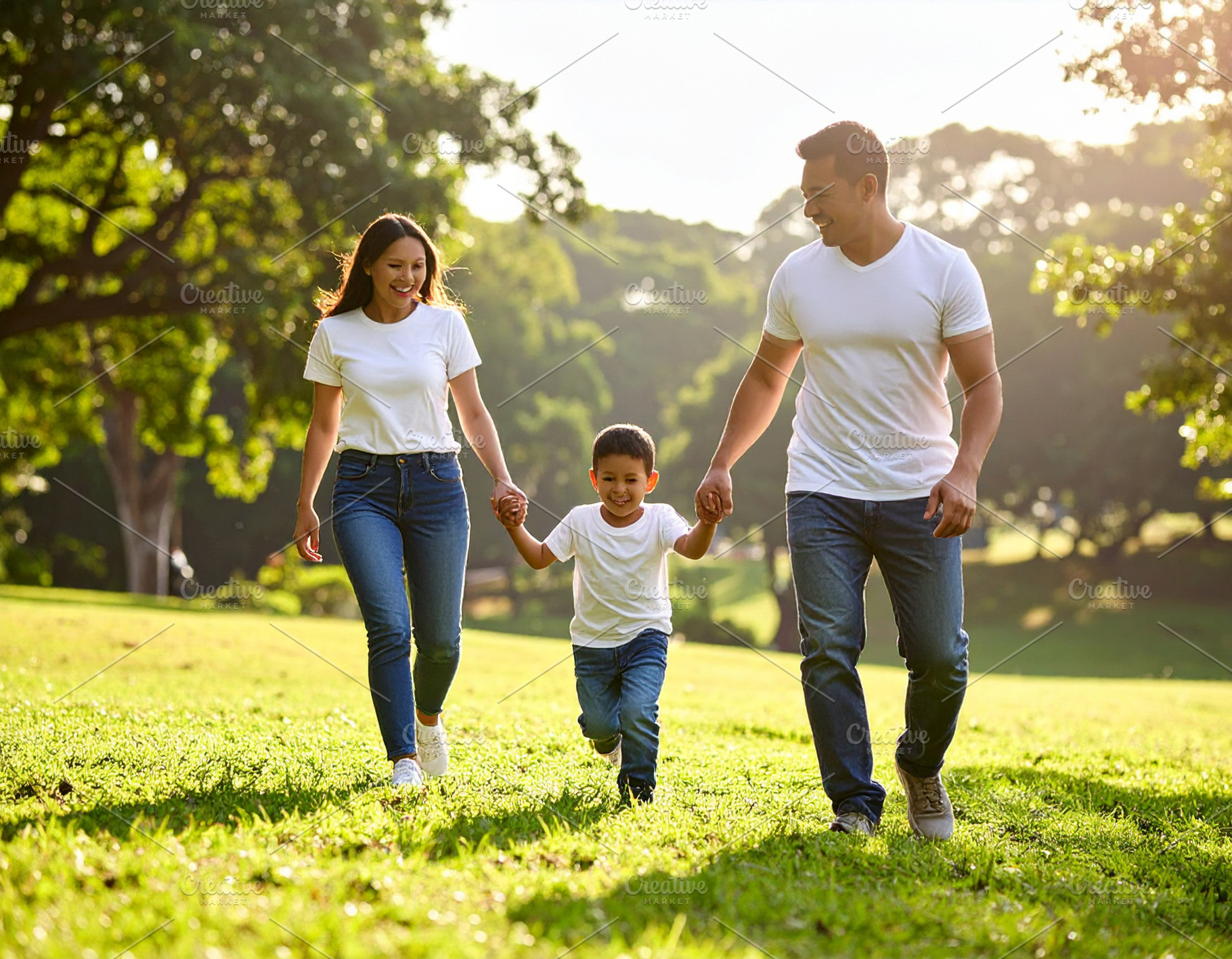 Happy young family playing at park, a Person Photo by DanFLCreativo