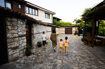 Family walking in the street of old town of Nessebar, Bulgaria., a Person Photo by AS photostudio