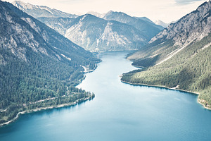 Woman on top of mountain near lake featuring achievement, active, and activity