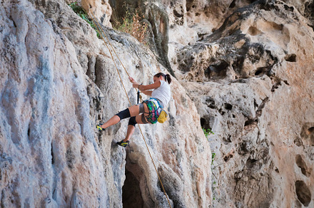 Young woman rock climbing on karst l featuring climbing, rock, and climber