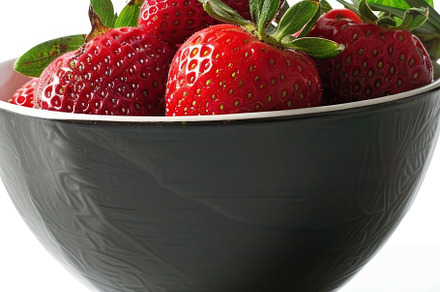 A bowl filled with juicy red strawbe, a Photo by LOGOCREATIVE