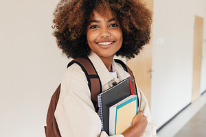 Student girl with books smiling, a Person Photo by Artem Varnitsin