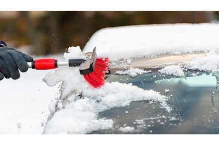 Human hand cleaning car from snow in, a Transportation Photo by WildMedia