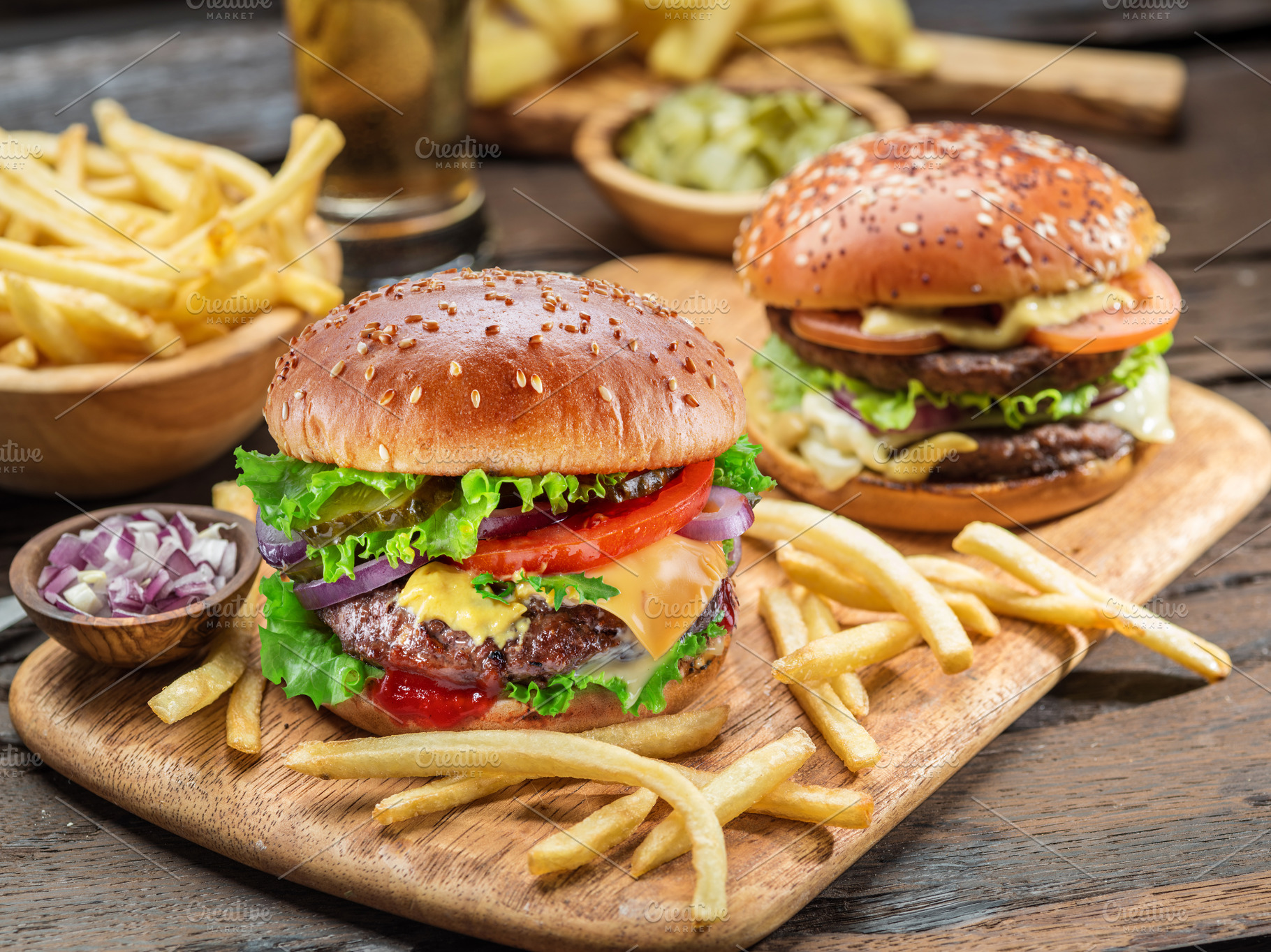 Hamburgers and French fries on the wooden tray., a Food & Drink Photo by Volff